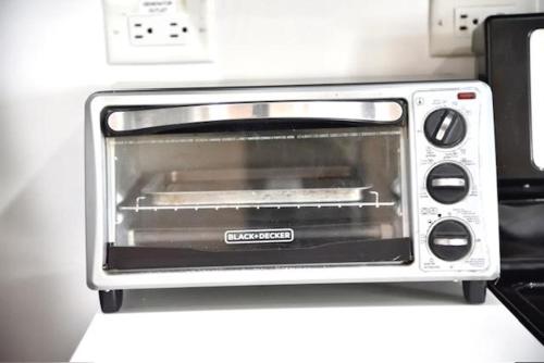 a toaster oven sitting on top of a counter at The Brompton's Luxury Apartment in Kingston
