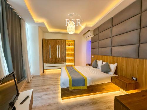 a hotel room with a bed and a tv at Elite Suites Hurghada in Hurghada