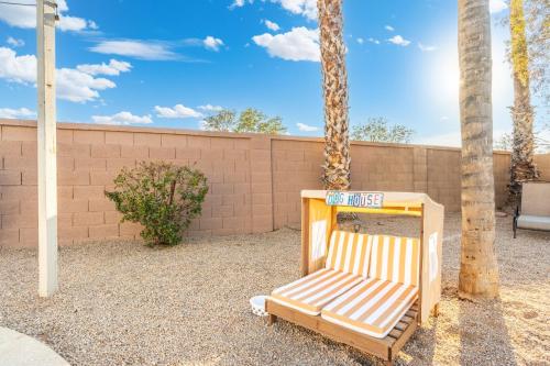 a wooden chair sitting in front of a wall at Desert Tails! Most Pet Friendly Pool & Fire Pit in Chandler
