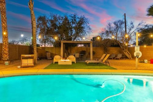 a swimming pool at night with a gazebo at Desert Tails! Most Pet Friendly Pool & Fire Pit in Chandler