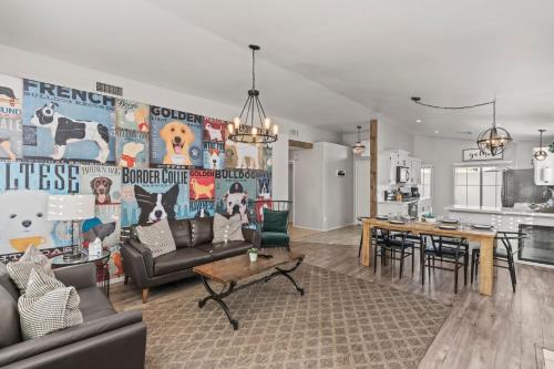 a living room with a couch and a table at Desert Tails! Most Pet Friendly Pool & Fire Pit in Chandler