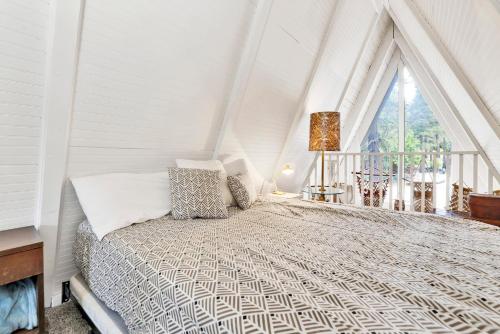 a bed in a room with a large window at Sunrise cottage #1800 in Big Bear City