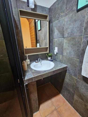 a bathroom with a sink and a mirror at Zihua 6bed 3bath Home for 12 with Direct Access to Beach in Zihuatanejo