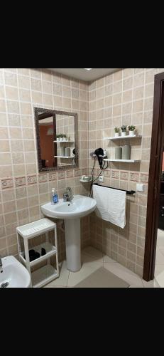 a bathroom with a sink and a mirror at Hanae malabata in Tangier