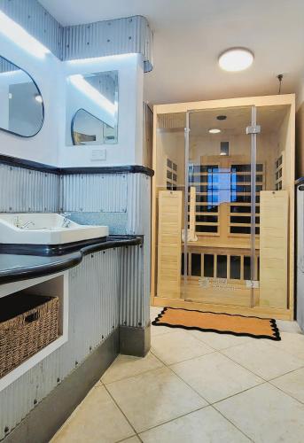 a bathroom with a sink and a shower at Urban Cottage in Masterton
