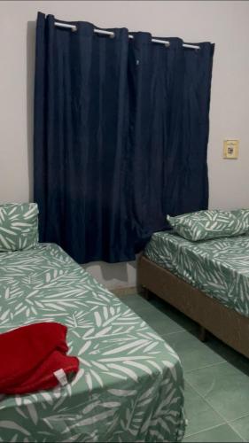 Ένα ή περισσότερα κρεβάτια σε δωμάτιο στο Apartamento de praia 02