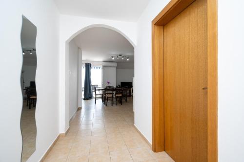 a hallway with an archway leading to a dining room at Apartments with swimming pool Zubovici, Pag - 9365 in Zubovići