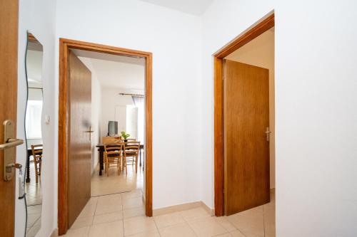 a hallway with a door leading to a dining room at Apartments with swimming pool Zubovici, Pag - 9365 in Zubovići