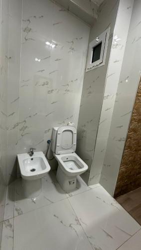 a bathroom with a toilet and a sink at Star beach in M'diq