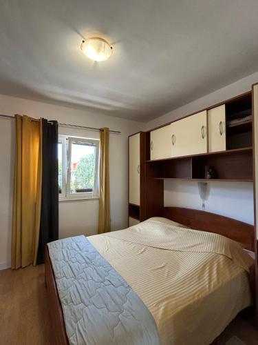 a bedroom with a bed and a window at Apartment Orebic 10082b in Orebić