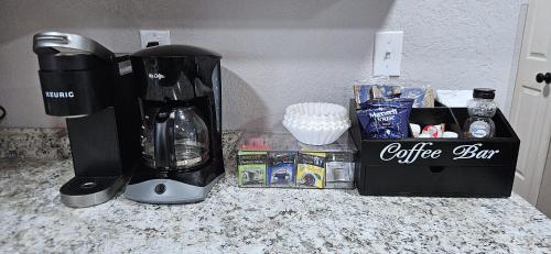 a coffeemaker and a coffee maker on a counter at 3Bd, King, Brkfst, Large TVs, WD, Sleeps 11, BBQ in Page
