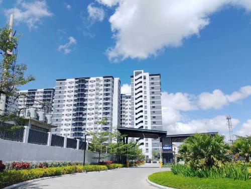a city with tall white buildings in the background at Baba Staytion1 of SMDC Style Condo in Iloilo City