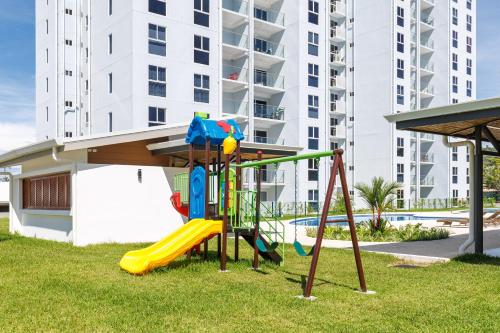 a playground in front of a apartment building at Viva Jaco II in Jacó