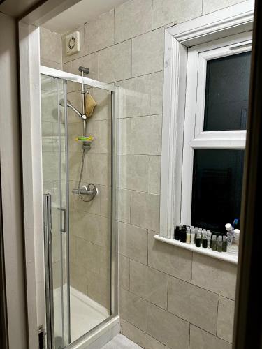 a shower with a glass door in a bathroom at Lucifer in London