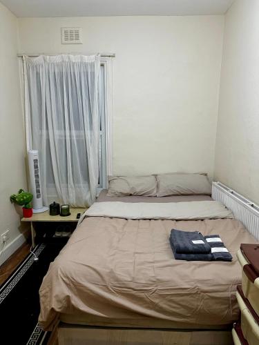 a bedroom with a bed and a window at Lucifer in London