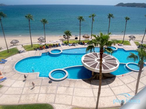 an overhead view of a swimming pool next to the beach at Playa Blanca Premier Unit 504 in San Carlos