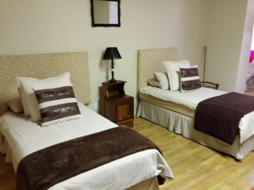 A bed or beds in a room at Uitenhage Apartments