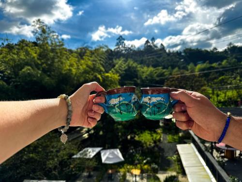 two people holding up glasses in their hands at Tierra Maravilla in Salento