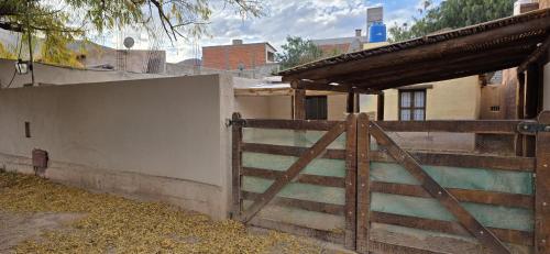 a wooden gate in front of a house at Casa en Tilcara - Espaciosa, equipada y lista para disfrutar in Tilcara