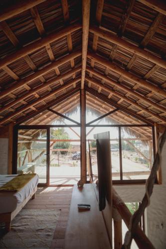 a room with a large window in a house at Toninas México Bungalow in Celestino Gasca