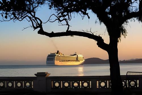 a cruise ship on the water at sunset at Lindo Apto Beira Mar - Ponta da Praia - Santos in Santos