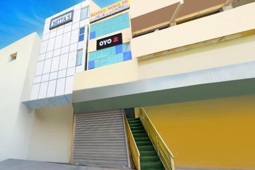 a building with a door and stairs in front at Hotel O MAK RESIDENCE in Shamshabad