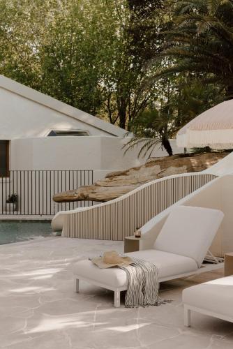 a living room with white furniture on a patio at The Ambers at Port Stephens in Bobs Farm