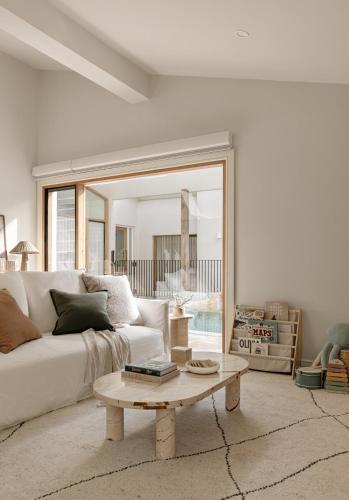 a living room with a white couch and a coffee table at The Ambers at Port Stephens in Bobs Farm