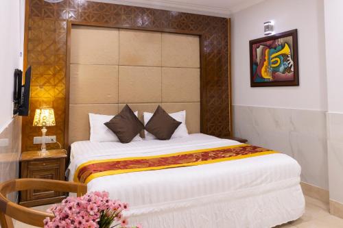 a bedroom with a large bed in a room at Atana Airport Hotel in Ho Chi Minh City