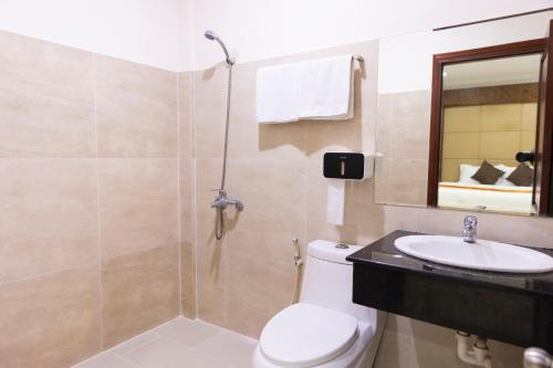 a bathroom with a toilet and a sink and a shower at Atana Airport Hotel in Ho Chi Minh City