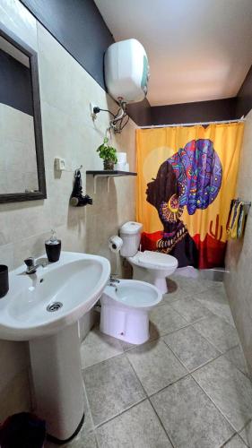 a bathroom with a sink and a toilet at Celina's Cozy Studio & Beach Life in One in Santa Maria