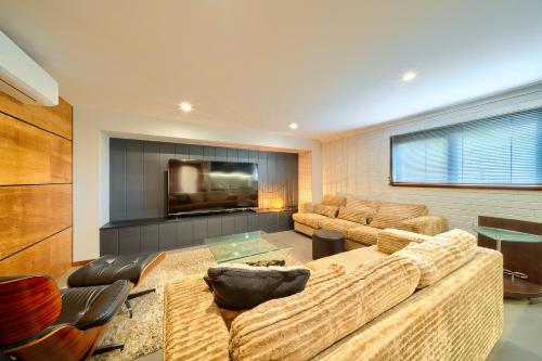 a living room with a couch and a tv at Aloft Mt Clarence in Albany