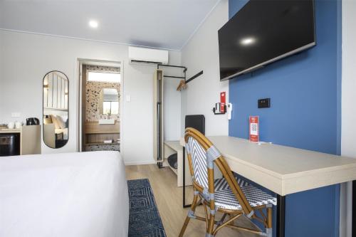 a kitchen with a table and chairs in a room at Nightcap at Queens Beach Hotel in Bowen