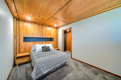 a bedroom with a bed and a wooden wall at Aloft Mt Clarence in Albany