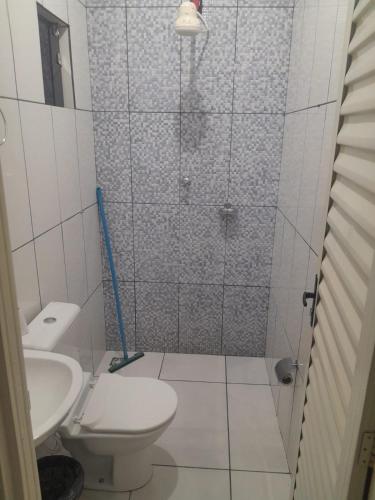 a bathroom with a shower with a toilet and a sink at Pousada Itororó in Bom Jesus da Lapa