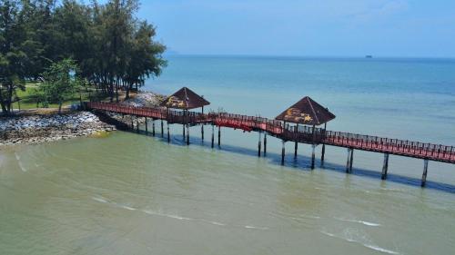 a pier in the water next to the ocean at 13pax BAYU EXECUTIVE SUITE 3R2B, SEASIDE, ROOFTOP BBQ, WATERSPORT, Pool, Wifi, 50"TV in Port Dickson