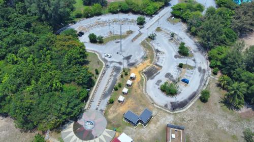 an aerial view of a park with cars parked at 13pax BAYU EXECUTIVE SUITE 3R2B, SEASIDE, ROOFTOP BBQ, WATERSPORT, Pool, Wifi, 50"TV in Port Dickson