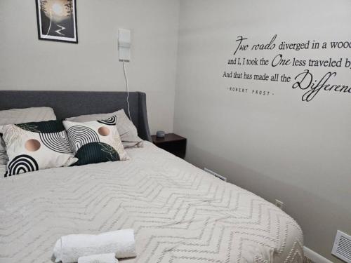 a bedroom with a bed with a quote on the wall at Fab 50's Firestone Flat! in Akron