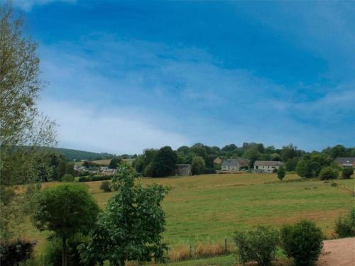 a field of grass with houses in the distance at Charming Family Home in Esneux in Esneux