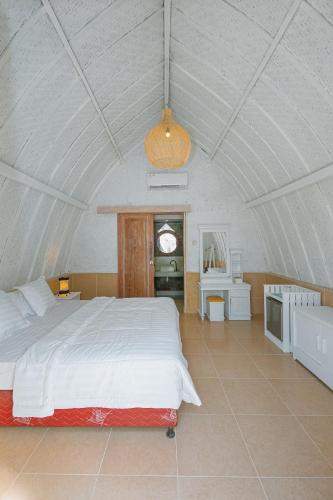 a bedroom with a large bed in a tent at New Life Village in Gili Trawangan