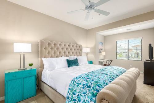 a bedroom with a bed with a blue dresser and a ceiling fan at Queen Creek #139 Chandler in Chandler