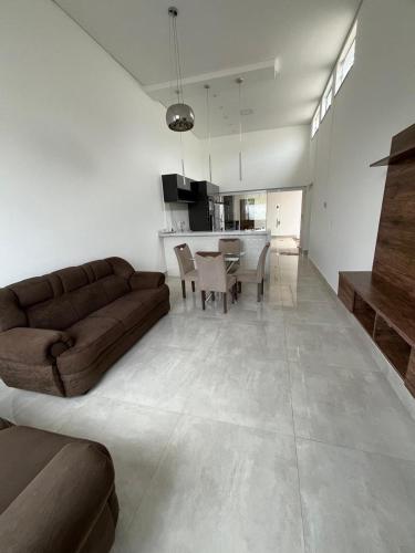 a living room with a brown couch and a table at Espaço Ideal in Passos