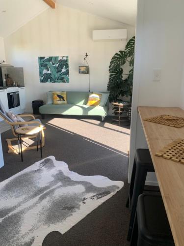 a living room with a couch and a table at Vida in Turangi