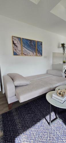 a large bed in a room with a couch and a table at Nala Host - 2BR Apartment Seaside Bliss in Hulhumale