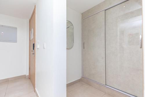a room with a sliding door and a mirror at CasaNova Airport Suites in Accra