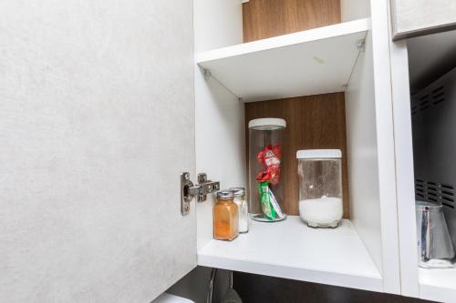 a kitchen pantry with a shelf in a kitchen at CasaNova Airport Suites in Accra