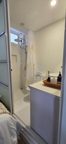 a bathroom with a shower and a sink and a toilet at Nala Host - 2BR Apartment Seaside Bliss in Hulhumale