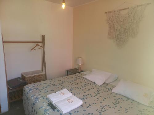 a bedroom with a bed with two towels on it at Hospedaje velilu in Ica