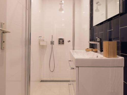 une salle de bain blanche avec une douche et un lavabo dans l'établissement Villa familiale en bord de mer avec 6 chambres, WiFi, animaux admis, proche Saint-Brevin-l'Océan - FR-1-364-170, à Saint-Brévin-les-Pins