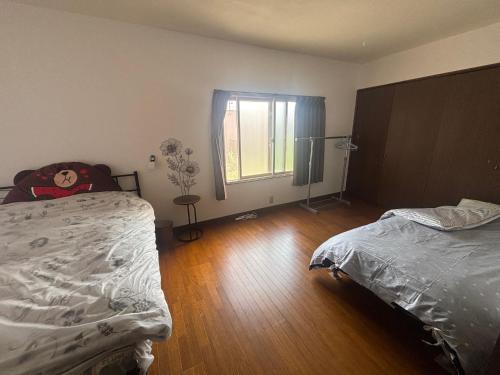 a bedroom with a bed and a window in it at 富良野 星野家 in Furano